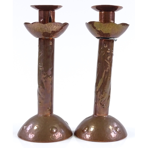 25 - A pair of Newlyn Arts and Crafts copper candlesticks, with relief embossed fish decoration, impresse... 