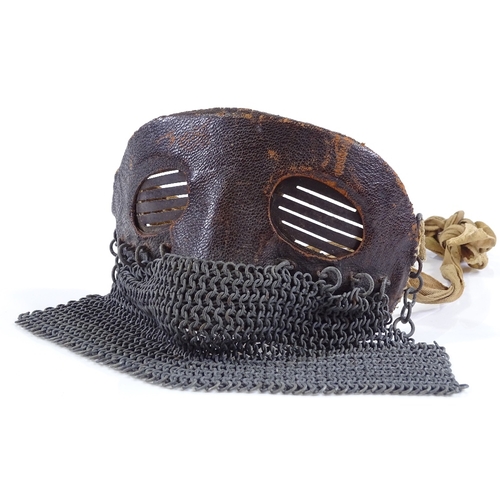 43 - A First War Period tank crew mask, leather covered steel upper part with chain link lower guard and ... 