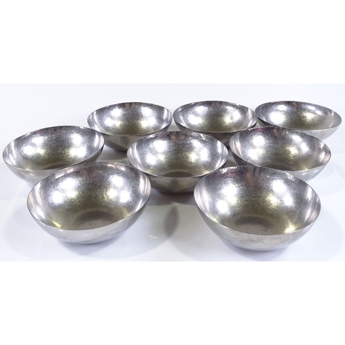 58 - A set of 8 Keswick School of Industrial Arts planished metal bowls, impressed marks, serial number K... 