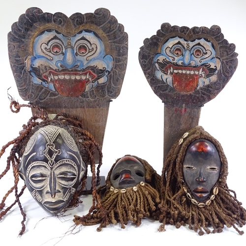 62 - A group of modern African Tribal carved wood masks and two Javanese theatre masks.