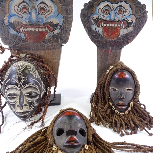 62 - A group of modern African Tribal carved wood masks and two Javanese theatre masks.