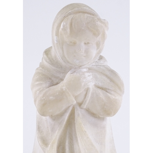 63 - An early 20th century carved alabaster sculpture of a young girl in a raincoat, signed P Sandy?, hei... 