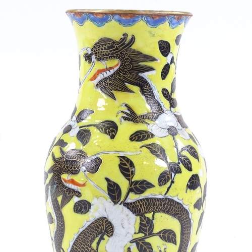 65 - A Chinese porcelain yellow ground vase, with black and gilt dragon decoration and chrysanthemums, he... 