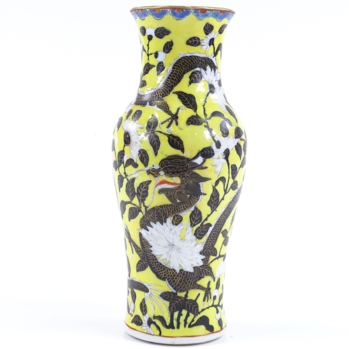 65 - A Chinese porcelain yellow ground vase, with black and gilt dragon decoration and chrysanthemums, he... 