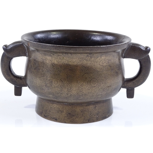7 - A Chinese cast-bronze 2-handled incense burner with engraved geometric designs, rim diameter 12cm, h... 