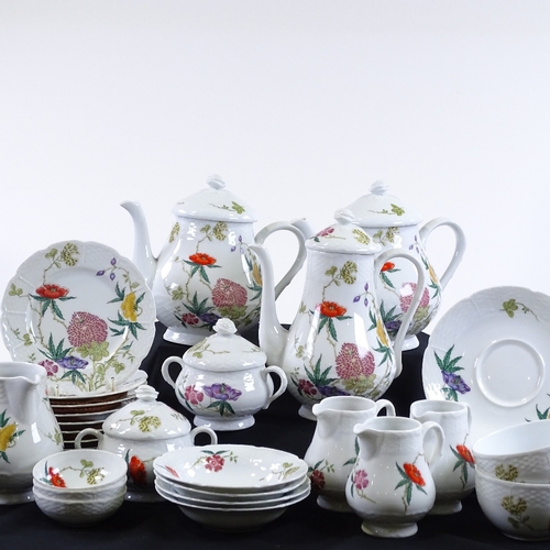 78 - A Limoges porcelain wild flower design tea and coffee service, including 2 teapots, a coffee pot, 5 ... 