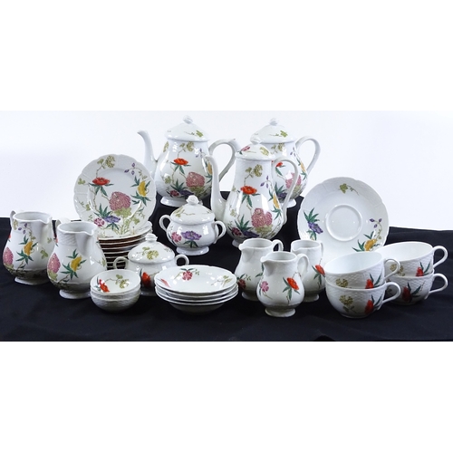 78 - A Limoges porcelain wild flower design tea and coffee service, including 2 teapots, a coffee pot, 5 ... 