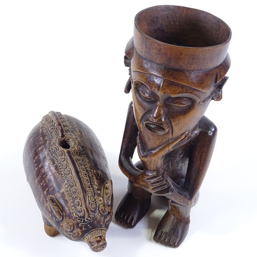 82 - An African carved and stained wood Tribal pot, in the form of a seated man, height 27cm, together wi... 