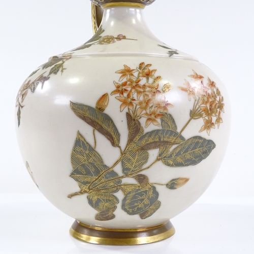 89 - A Royal Worcester ewer, with hand painted and gilded floral designs, and reticulated handle, pattern... 