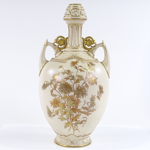 90 - A Royal Worcester 2-handled narrow-necked vase, with hand painted and gilded floral decoration, and ... 