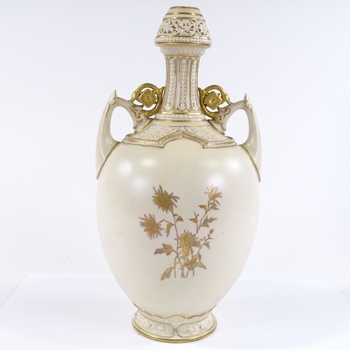 90 - A Royal Worcester 2-handled narrow-necked vase, with hand painted and gilded floral decoration, and ... 