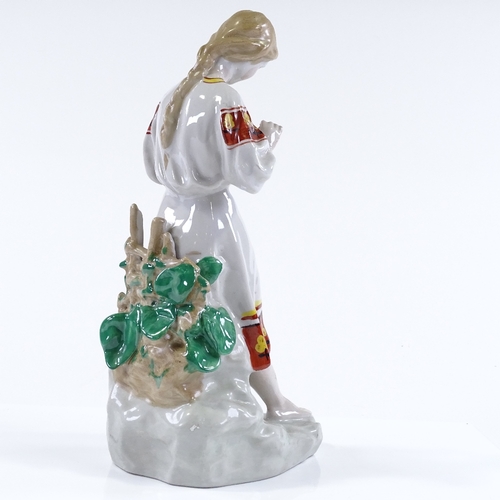 95 - A Russian porcelain figure of a girl holding a flower, height 29cm