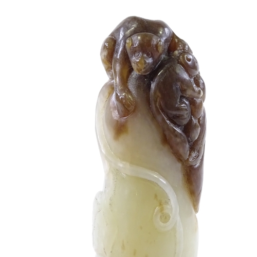 99 - A Chinese 2-colour jade octopus, surmounted by monkey figures, length 10cm