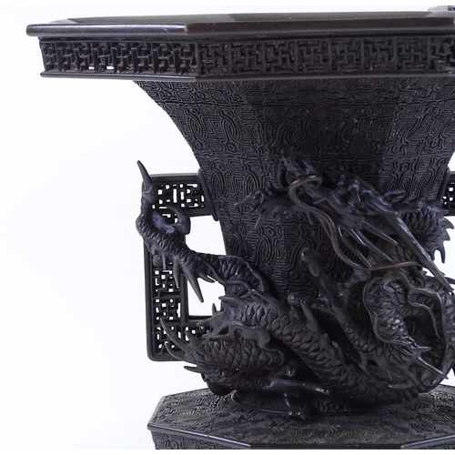 119 - A pair of Japanese Meiji period bronze vases, 3-dimensional dragon mounted necks, with pierced friez... 