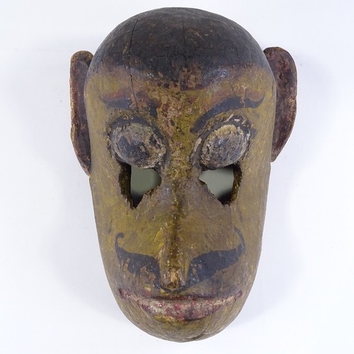 107 - A 19th century Indian carved and painted wood Tribal monkey mask, height 32cm