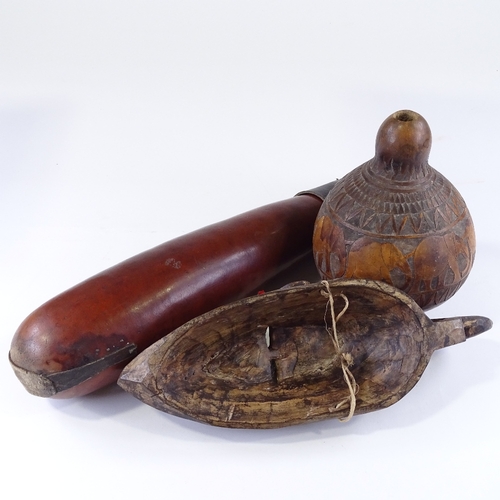 109 - An African carved wood Tribal mask, length 40cm, a beadwork mounted leather gourd, and an elephant c... 