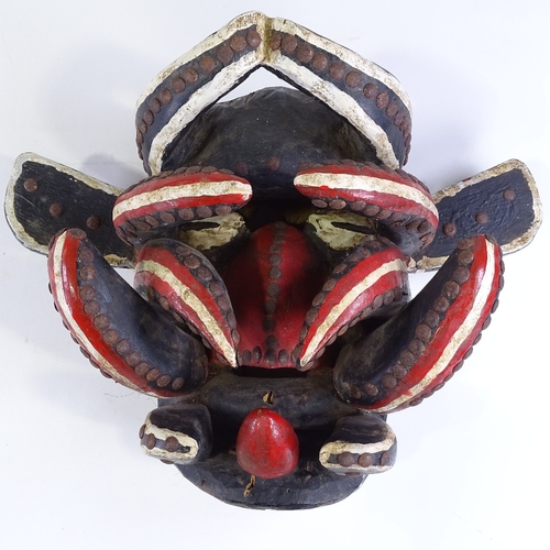 110 - A carved and painted wood African Tribal mask with metal studded decoration, height 34cm, and anothe... 