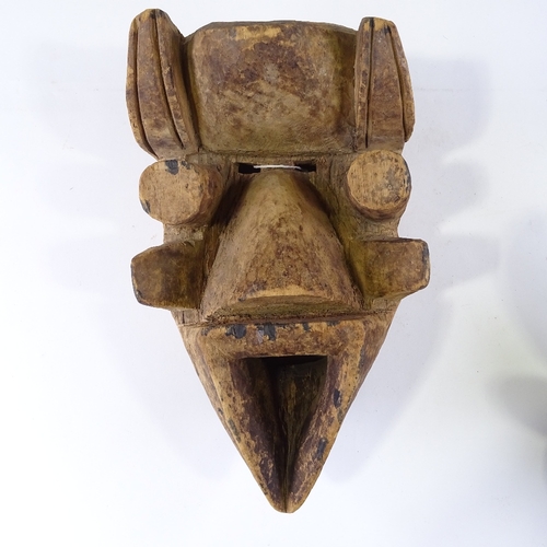 110 - A carved and painted wood African Tribal mask with metal studded decoration, height 34cm, and anothe... 