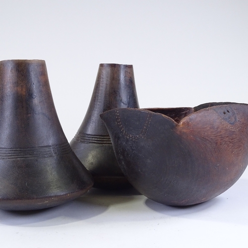 116 - A pair of African turned hardwood vases, height 24cm, and a similar carved wood bowl, length 26cm (3... 