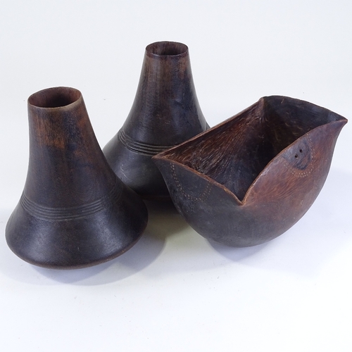 116 - A pair of African turned hardwood vases, height 24cm, and a similar carved wood bowl, length 26cm (3... 