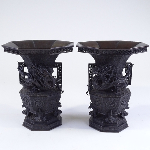 119 - A pair of Japanese Meiji period bronze vases, 3-dimensional dragon mounted necks, with pierced friez... 