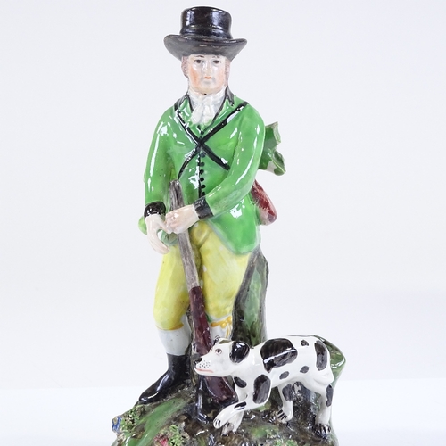 122 - A 19th century Staffordshire pearlware figure of a gamekeeper and hound, height 18cm