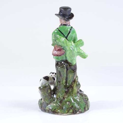 122 - A 19th century Staffordshire pearlware figure of a gamekeeper and hound, height 18cm