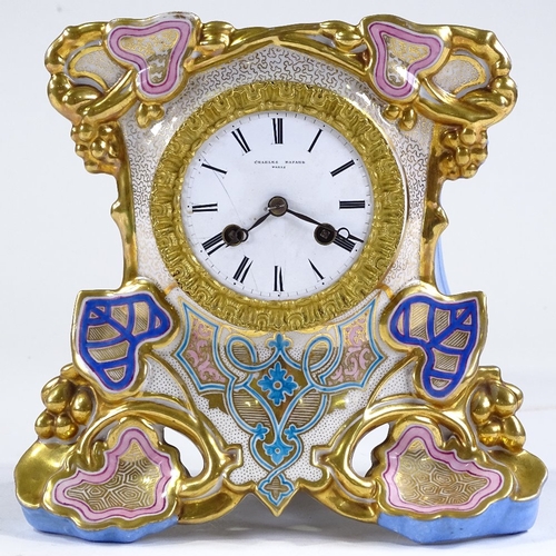 126 - An ornate 19th century French porcelain-cased mantel clock with gilded decoration, enamel dial signe... 