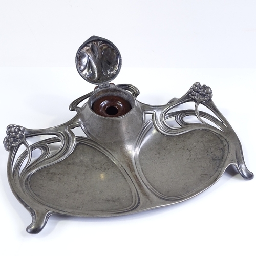 131 - A WMF Art Nouveau relief-cast pewter desk stand with inkwell, width 23cm