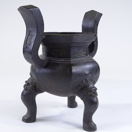 136 - A Chinese patinated bronze incense burner, resting on 3 dragon design feet, overall height 28cm