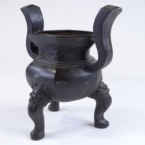 136 - A Chinese patinated bronze incense burner, resting on 3 dragon design feet, overall height 28cm