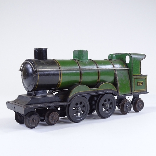 24 - A Vintage tinplate toy carpet steam locomotive, length 32cm