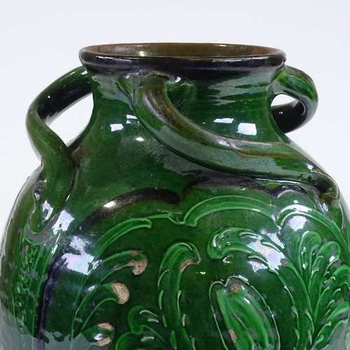 26 - A Brannam Barnstaple Pottery green-glazed vase, with incised scroll decorated panels and 3 spirallin... 