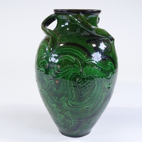 26 - A Brannam Barnstaple Pottery green-glazed vase, with incised scroll decorated panels and 3 spirallin... 