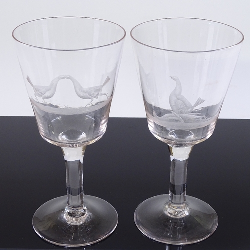 28 - A pair of 19th century funnel-shaped wine glasses, with wheel-cut fighting cock designs, height 20cm... 
