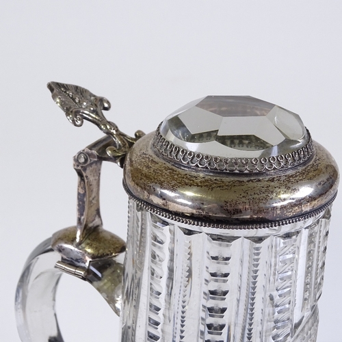 29 - A 19th century cut-glass lidded tankard of small size, with unmarked silver mounts and inset facet-c... 