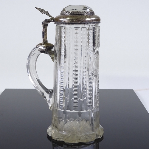 29 - A 19th century cut-glass lidded tankard of small size, with unmarked silver mounts and inset facet-c... 