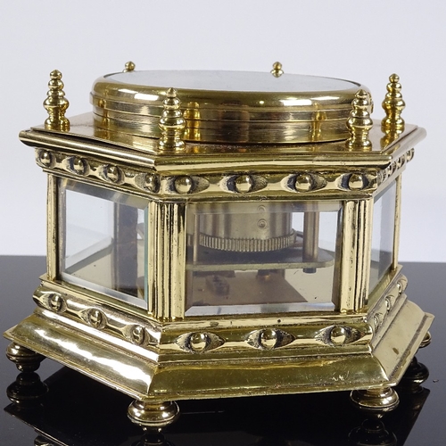 30 - A Victorian brass-cased desk clock of hexagonal form, enamel dial and secondary dial, bevel-glass pa... 