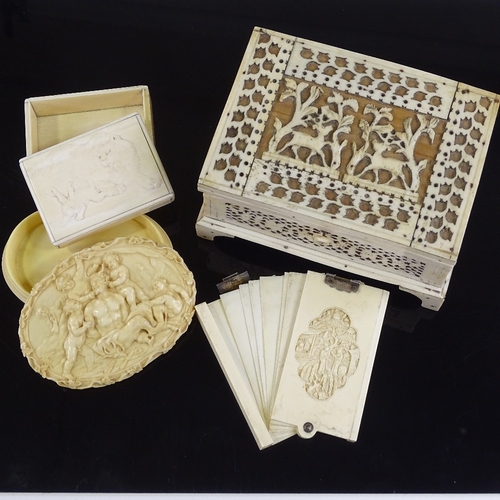 31 - A 19th century bone fretwork decorated jewel box, length 14cm, a Chinese relief carved ivory card ca... 