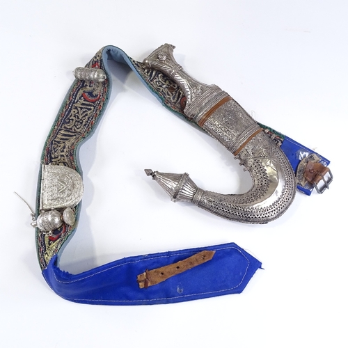 43 - An Arab white metal mounted jambiya knife with belt and fittings
