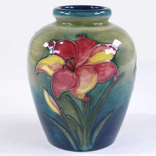 46 - A Moorcroft Pottery Lily design vase, painted signature, height 16cm