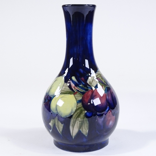 75 - A Moorcroft Pottery plum design blue ground narrow-neck vase, painted signature, height 23cm