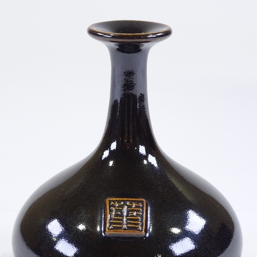 86 - Poh Chap Yeap (1927 - 2007), porcelain bottle vase with black tenmoku glaze, and applied plaque/seal... 