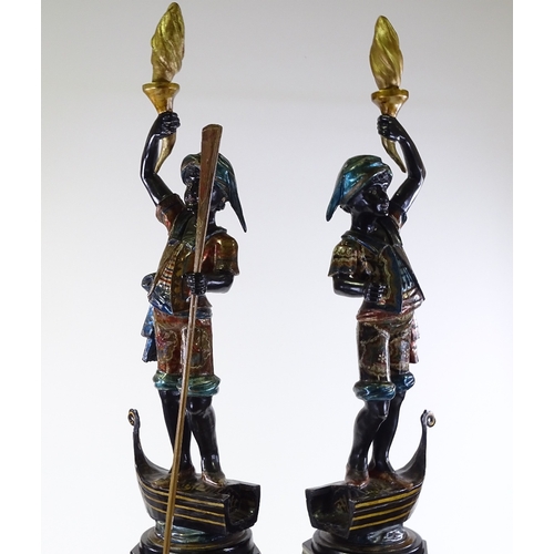 3 - A pair of Italian carved and painted wood gondolier torchere figures, on gilded octagonal pedestals,... 