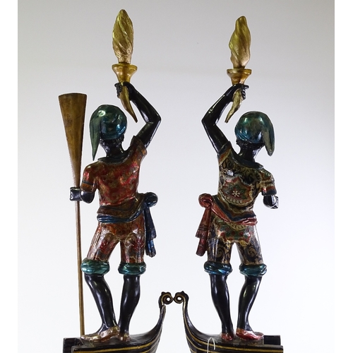 3 - A pair of Italian carved and painted wood gondolier torchere figures, on gilded octagonal pedestals,... 