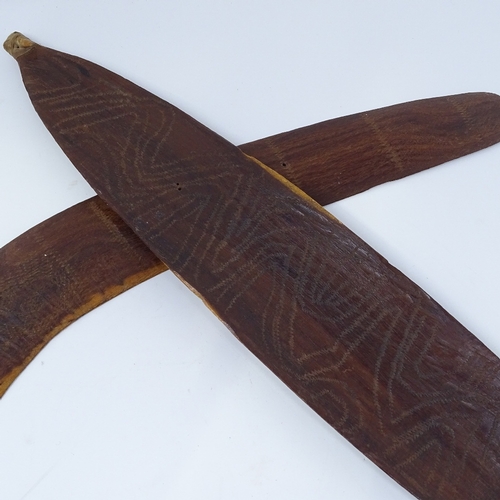 106 - An Aboriginal hardwood boomerang, with engraved zigzag designs, and a similar engraved woomera, leng... 