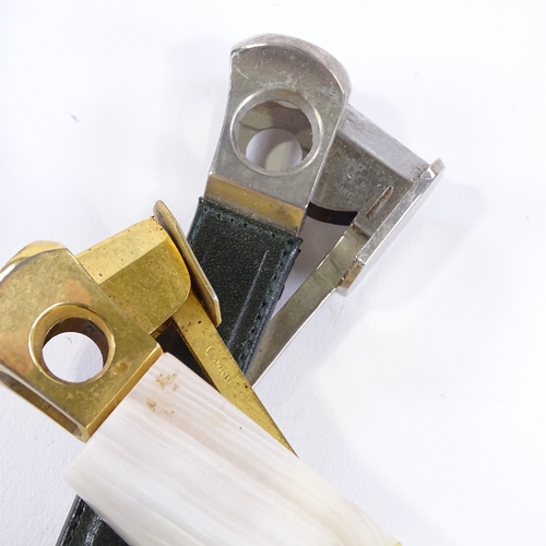 95 - 2 Antique cigar cutters, and another