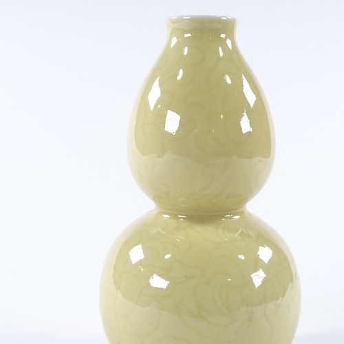 104 - A Chinese yellow glaze porcelain double gourd vase, with incised floral designs, 4 character mark, h... 