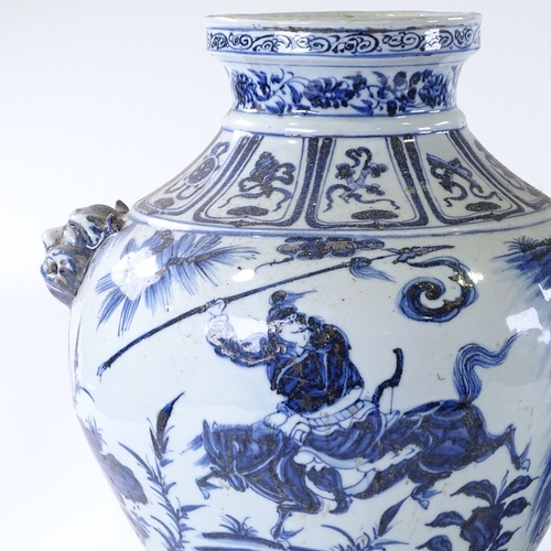 105 - A large pair of Chinese blue and white porcelain jars, with relief dragon mask handles and painted d... 