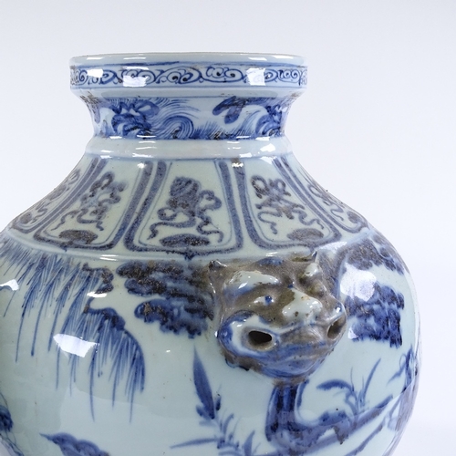 105 - A large pair of Chinese blue and white porcelain jars, with relief dragon mask handles and painted d... 